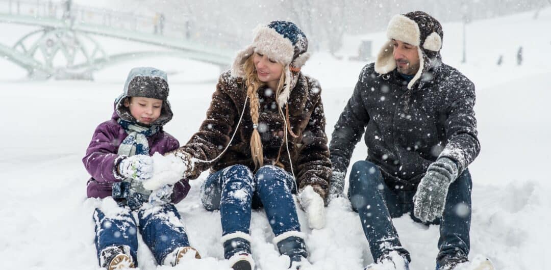 Winter holiday packing hacks - Fun Family Experiences To Consider for Winter Break - sitting in snow