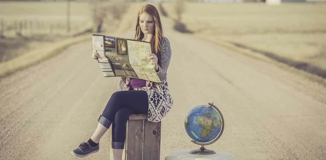 10 Big Travel Trends That Will Fade with Generation X - girl with globe and map