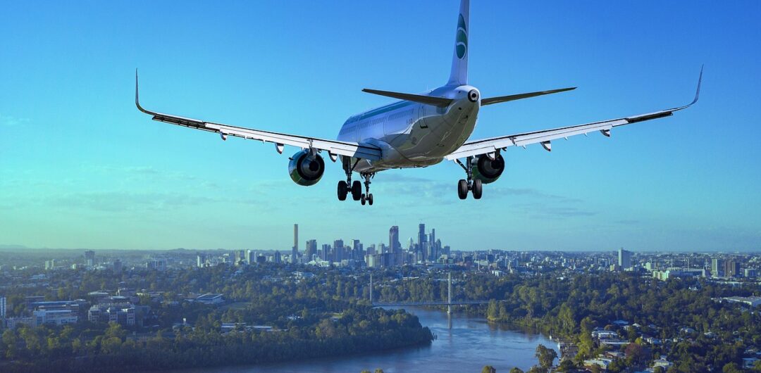 6 Best Companies for Airport Transfers - Airplane Flying Over City