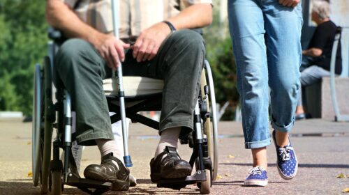 How to Travel with Someone in a Wheelchair - A Person Walking Besides Someone in a Wheelchair The Vacation Safety Checklist Most Families Don’t Think About Until It’s Too Late