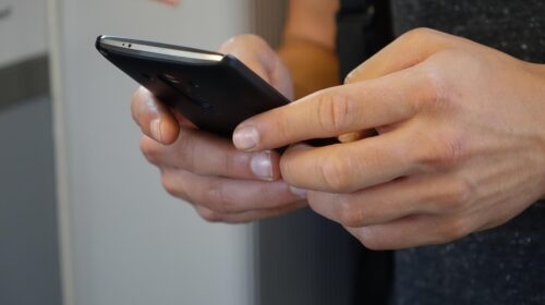 How to Avoid Flight Roaming Fees Online Card Games Five Benefits You Need to Know About - Close-Up on Hands Holding a Phone What to Expect From a Nationwide Auto Transport Service