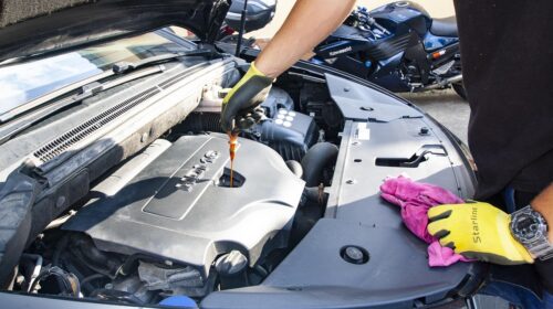 Beginners Guide To Car Fluids What You Need In Your Garage - Mechanic Changing Oil