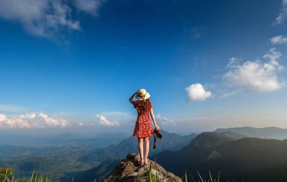 Travel Tips for a More Comfortable and Enjoyable Journey - Woman in the Mountains Holding a Camera