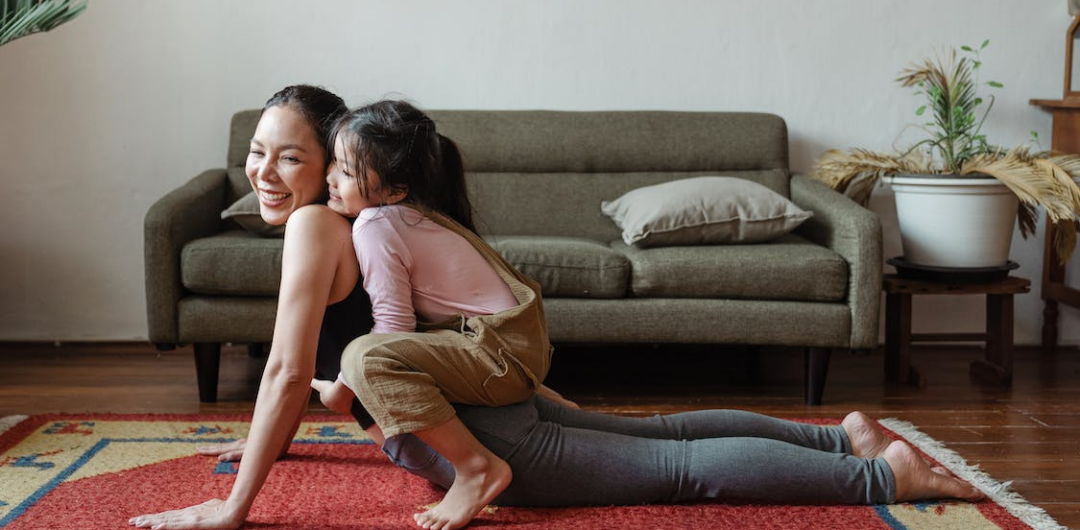 7 Tips for Improving Your Overall Well-being in 2026 - Mom and Daughter Doing Yoga