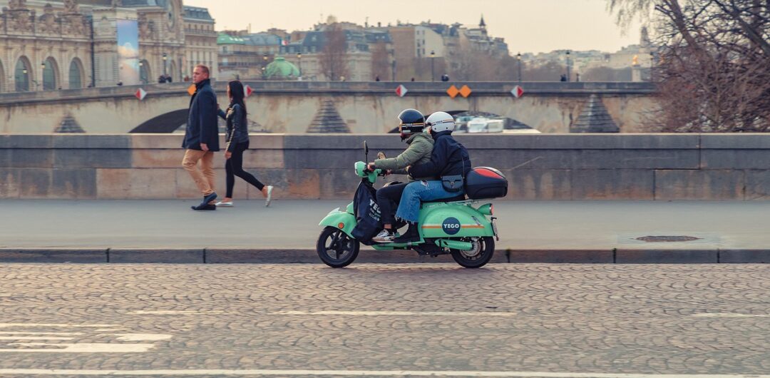 4 Reasons a Scooter Is Perfect for Short Trips - Two People Riding a Scooter