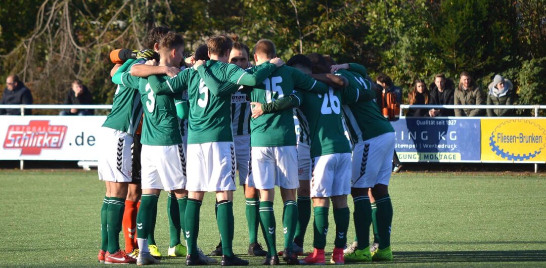 4 Ways Matching Gear Makes Group Trips Better - Soccer Team Huddled Together