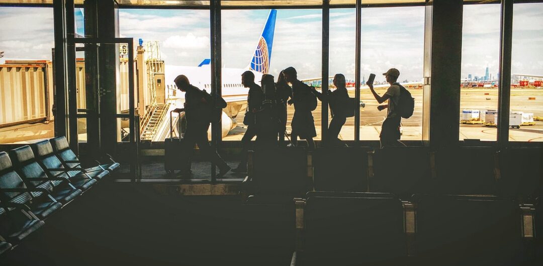 4 Ways Matching Gear Makes Group Trips Better - Travel Group Walking Through Airport