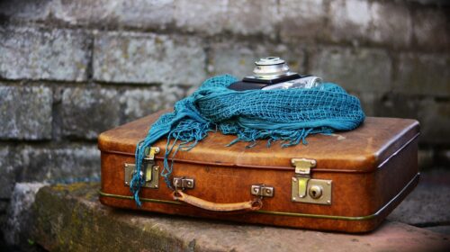 Why Nostalgic Travel Experiences are Becoming Popular Again - Vintage Camera and Suitcase