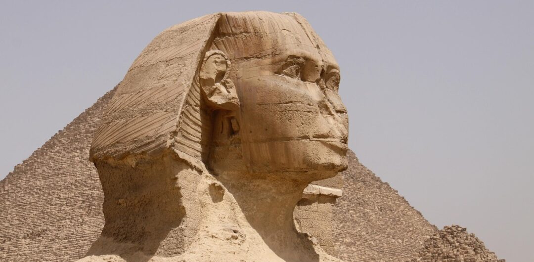 The Most Meaningful Cultural Experiences in Egypt for Curious Travelers - Sphinx with a Pyramid Behind it