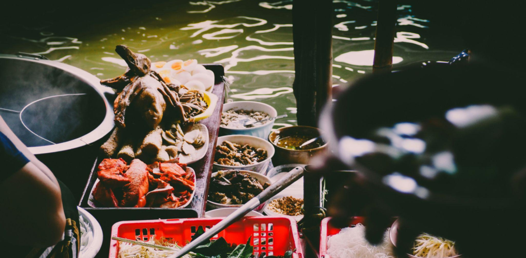 Food-Focused Travel: How to Find Local Flavor Without Over-planning 1 Food-Focused Travel: How to Find Local Flavor Without Over-planning - Piles of Food at a Floating Market in Bangkok